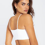 Vista frontal del top con tiras finas y diseño minimalista, color blanco